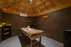 a room with a table in a room with a ceiling at Hotel Xaluca Dades in Boumalne Dades