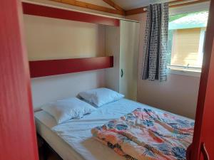 a bed in a small room with a bunk bed at Camping du Nizour in Sireuil +76 photos