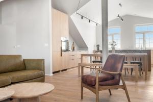 a living room with a couch and tables at Amtmann Residence by Heimaleiga in Selfoss
