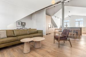 a living room with a couch and a table at Amtmann Residence by Heimaleiga in Selfoss