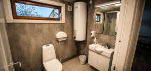 a bathroom with a toilet and a sink and a mirror at Haraldvollen Red Cross Center in Bardufoss +59 photos