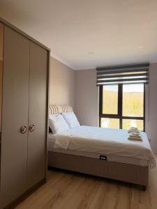 a bedroom with a large bed and a window at Amphora Palace Apartment Complex in Golden Sands