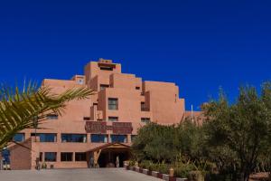 a large brown building with a blue sky in the background at Hotel Xaluca Dades in Boumalne Dades