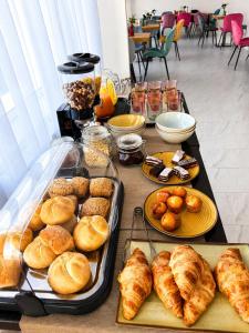 a table with a bunch of pastries and other foods at Rosetti Inn in Cluj-Napoca
