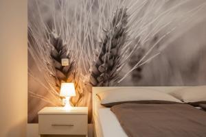 a bedroom with a bed and a wall with feathers at Istria Sea Side Apartments Lina in Labin
