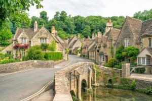 an old stone bridge in a village with houses at Holiday Inn Express Swindon West by IHG in Swindon
