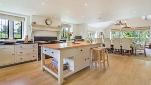 a kitchen with a island in the middle of a room at Grindstone Mill in Alderley