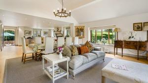 a living room with a couch and a table at Grindstone Mill in Alderley +19 photos