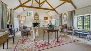 an ornate living room with a table and a fireplace at Grindstone Mill in Alderley