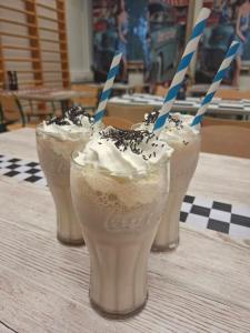 three milkshakes are sitting on a table at Schools Out OY in Loviisa