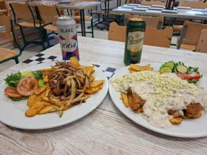 two white plates of food on a table with food at Schools Out OY in Loviisa +14 photos