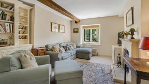a living room with two couches and a fireplace at Grindstone Mill in Alderley