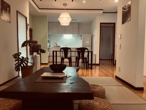 a kitchen and living room with a table and chairs at HOUSE26 Private Villa near Green Expo Yokohama in Machida