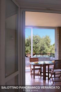 a sliding glass door leading to a patio with a table at Villa Gelsi a Pesaro in Pesaro