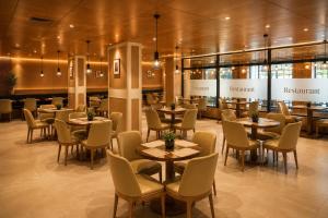 a dining room with tables and chairs and a restaurant at Twin Burj Hotel in Nouakchott