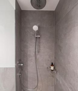 a shower with a glass door in a bathroom at H24 Hotel Berlin Grünau in Berlin +22 photos