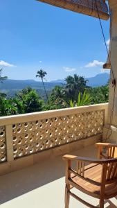 a balcony with a table and a chair and a view at Double view point sibetan in Tenganan +7 photos