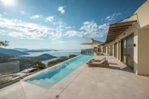 a villa with a swimming pool with a view at Villa Symposium Infinity in Sivota