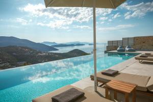 a swimming pool with a view of the ocean at Villa Symposium Infinity in Sivota