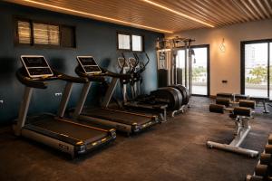 a gym with several treadmills and machines in a room at Twin Burj Hotel in Nouakchott