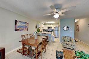 a kitchen and dining room with a table and a ceiling fan at Grand Caribbean Perdido Key #306 West in Perdido Key +14 photos