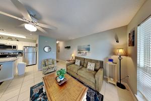 a living room with a couch and a table at Grand Caribbean Perdido Key #306 West in Perdido Key