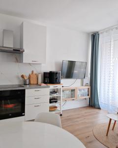 a kitchen with white cabinets and a white counter top at Villa apartment Laganini in Okrug Gornji +10 photos