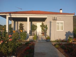 a house with a porch and stairs leading to it at Classic Guesthouse Nafplion in Nafplio