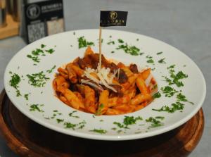 a plate of pasta with cheese on a table at Konak Zenobia in Midyat +43 photos