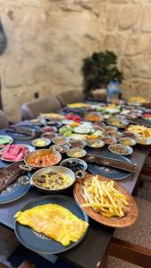 a long table with plates of food and french fries at Konak Zenobia in Midyat
