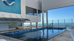 a swimming pool on top of a building at Costa do Mar Hotel in Fortaleza