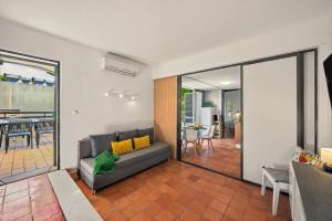 a living room with a couch and a balcony at Hakuna Matata House in Alvor