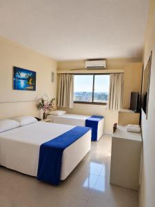 a hotel room with a bed and a large window at klein Ville Esteio Br in Esteio +35 photos