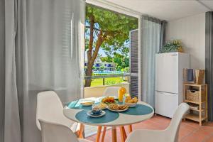 a dining room with a table and chairs and a refrigerator at Hakuna Matata House in Alvor