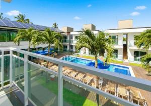 an image of the balcony of a hotel with a swimming pool at Pousada Oásis Tropical in Porto De Galinhas