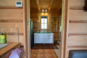 a bathroom with a sink in a wooden house at Domek na Górkach in Krościenko +31 photos