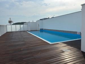 a swimming pool on the roof of a building at Wechta - Promenada Gwiazd 28 with Sea View, Free Rooftop Pool & Sauna in Międzyzdroje