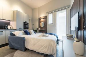 a bedroom with a large bed with towels on it at GuestHost - Vivaldi Inverno Apartment in Treviglio