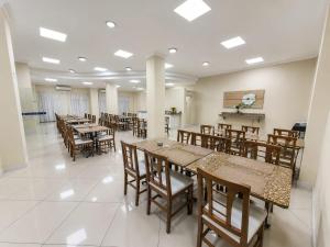a dining room with tables and wooden chairs at klein Ville Esteio Br in Esteio
