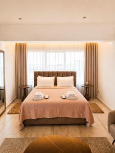 a bedroom with a bed with two towels on it at J Aurora in Nicosia