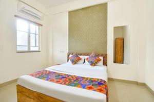 a bedroom with a large bed in a room at FabHotel Tiru Rooms in Pune +29 photos