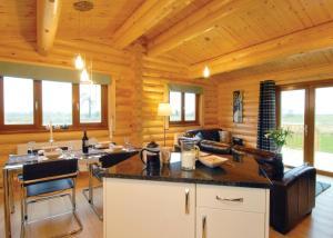 a kitchen and living room with wooden walls at Laxfield Lodges in Laxfield