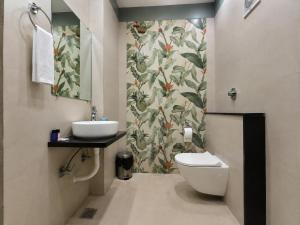 a bathroom with a toilet and a sink at Aaditri Inn in Gorakhpur +27 photos