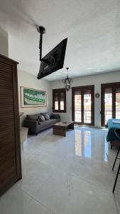 a living room with a couch and a tv at J&B Suites in Kavála
