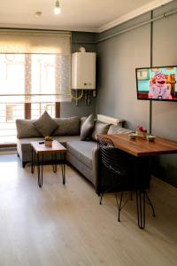 a living room with a couch and a table at Eylül Homes in Trabzon