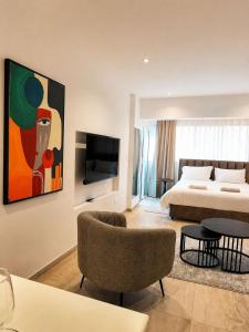 a hotel room with a bed and a tv at J Aurora in Nicosia
