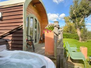 a house with a hot tub on a patio at The Pod At Egmont in Newenden
