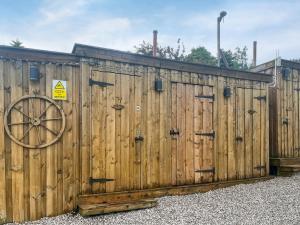 a wooden fence with a wheel on it at Pinhaw Beacon - Ukc9595 in Earby +12 photos