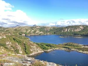 a view of a large lake in the mountains at Thistle Cottage - Uk5867 in Achmelvich +8 photos