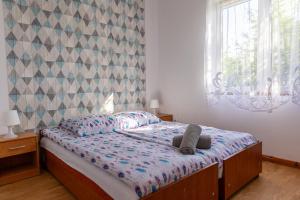 a bedroom with a bed with two towels on it at Leśna Oaza in Sasino